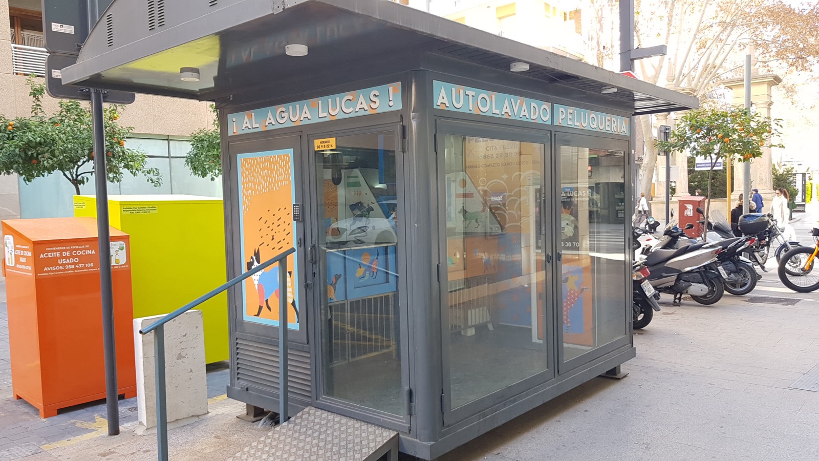 A dog grooming station with a raised table, dryer and storage.
